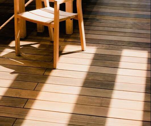 Wooden chair on stained outdoor decking