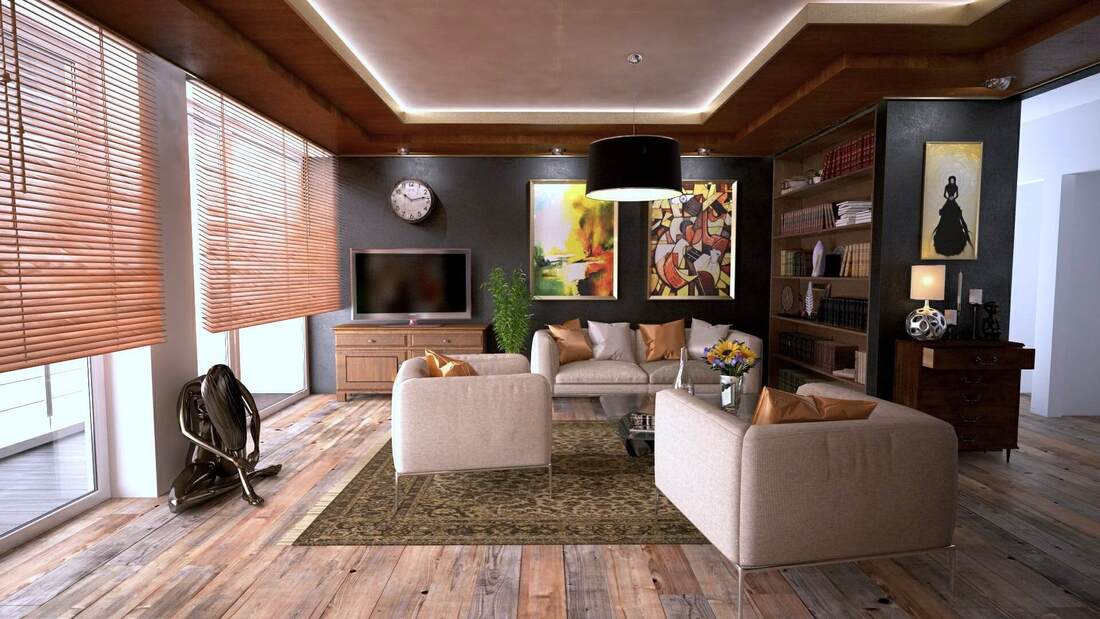 Dark hue warm Home lounge Interior with abstract paintings on the wall and coffee creme coloured couches and stained wooden floorboards