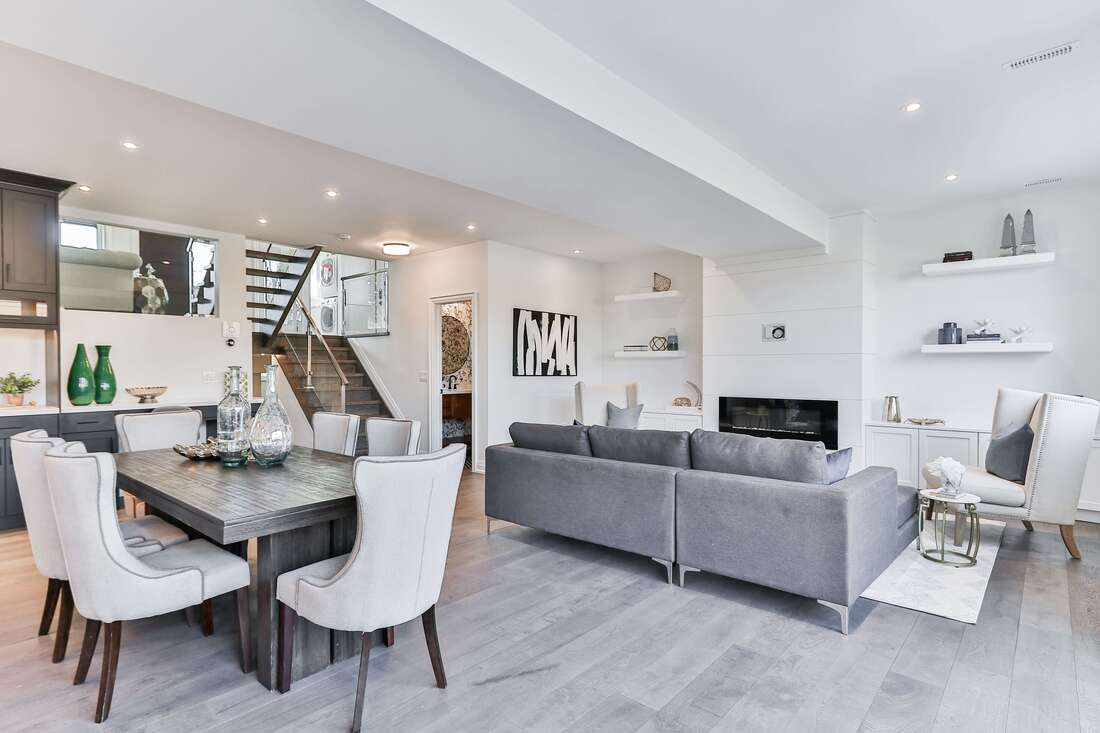 Modern interior home white furniture and walls with grey dining table and couches